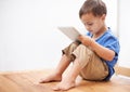 Boy, tablet and typing with games, home and internet with network, connection and digital app for learning. Child Royalty Free Stock Photo