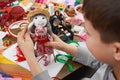Boy tailor learns to sew, dress for doll, handmade and handicraft concept