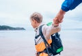 Boy takes his father hands. Active family vacation concept image