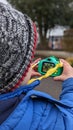 Boy takes photograph outside with his new toy camera