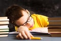 Boy taking a nap while finishing homework Royalty Free Stock Photo