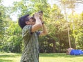 Boy taking photo by camera at camping site in forest Royalty Free Stock Photo