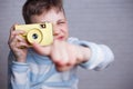 Boy taking a picture with vintage camera pointing on you. Photog Royalty Free Stock Photo