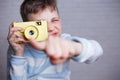 Boy taking a picture with vintage camera pointing on you. Photog