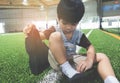 Boy taking shoes off ready for soccer training ground Royalty Free Stock Photo