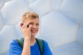 Boy talking on cell phone in the Olympic Park, Beijing Royalty Free Stock Photo