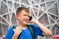 Boy talking on cell phone in the Olympic Park in Beijing Royalty Free Stock Photo