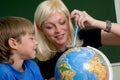 Boy and teacher with globe