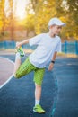 Boy Teen doing sports exercises on a stadium