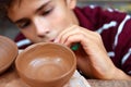 Boy teen potter clay bowl working
