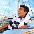 Boy teen sailor laying on marina boat chart map Royalty Free Stock Photo