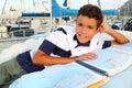 Boy teen sailor lying on marina boat chart map