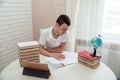 A boy schoolboy does his homework. Textbooks and notebooks on the table Royalty Free Stock Photo