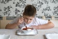 Boy teenager eating soup at kitchen table Royalty Free Stock Photo