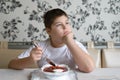 Boy teenager eating soup at kitchen table Royalty Free Stock Photo