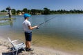 Boy teenager is fishing on the fishing rod in summer. Royalty Free Stock Photo