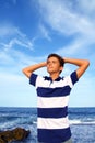 Boy teenager hands in head relaxed in blue ocean Royalty Free Stock Photo