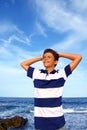 Boy teenager hands in head relaxed in blue ocean Royalty Free Stock Photo