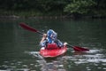 Boy teenager manages a canoe kayak on a wide river. Royalty Free Stock Photo