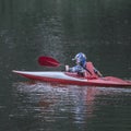 Boy teenager manages a canoe kayak on a wide river. Royalty Free Stock Photo