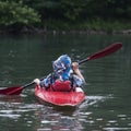 Boy teenager manages a canoe kayak on a wide river. Royalty Free Stock Photo