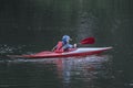 Boy teenager manages a canoe kayak on a wide river. Royalty Free Stock Photo