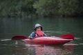 Boy teenager manages a canoe kayak on a wide river. Royalty Free Stock Photo