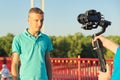 Boy teenager model and male photographer taking photos videos with camera and stabilizer Royalty Free Stock Photo