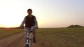 Boy teenager riding bicycle. Boy teenager riding bicycle goes to nature along the path steadicam shot motion video Royalty Free Stock Photo