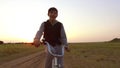 Boy teenager riding bicycle. Boy teenager riding bicycle goes to nature along the path steadicam shot motion video Royalty Free Stock Photo