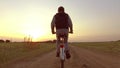 Boy teenager riding a bicycle. Boy teenager riding a bicycle goes to nature along the path steadicam video shot motion Royalty Free Stock Photo