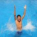 Boy teenager splashing water open arms pool Royalty Free Stock Photo