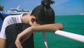 Boy teenager suffers from motion sickness while on a boat trip. Fear of traveling or illness of the virus during a