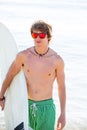 Boy teenager with surfboard on beach shore Royalty Free Stock Photo