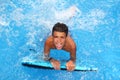 Boy teenager surfboard splashing blue water