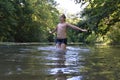 Boy teenager swims in river in summer Royalty Free Stock Photo