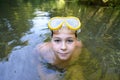 Boy teenager swims in river in summer Royalty Free Stock Photo