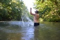 Boy teenager swims in river in summer Royalty Free Stock Photo