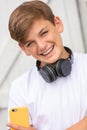 Boy teenager teen male child using cell phone and headphones Royalty Free Stock Photo