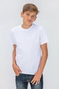 Boy teenager teen male child wearing a white t-shirt and jeans