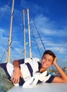 Boy teenager vacation laying marina boat smiling Royalty Free Stock Photo