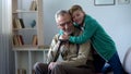 Boy tenderly embracing grandfather, family love, respect for older generation Royalty Free Stock Photo