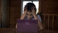 Boy think at the table near the tablet, clutching his head, insoluble situation