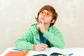 Boy thinking and doing homework. Little student boy studying and reading books Royalty Free Stock Photo