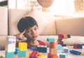 Boy thinking thoughful creating toy block