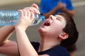 A boy thirsty eagerly drinking water Royalty Free Stock Photo