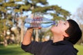 Boy thirsty eagerly drinking water