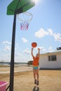 Boy throwing ball to basket Royalty Free Stock Photo