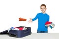 Boy throwing clothes to luggage bag Royalty Free Stock Photo