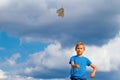Boy throwing paper plane against blue sky Royalty Free Stock Photo
